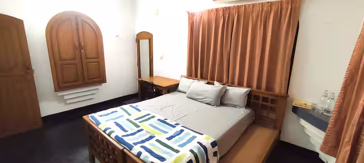 Bedroom with wooden bed and mirror